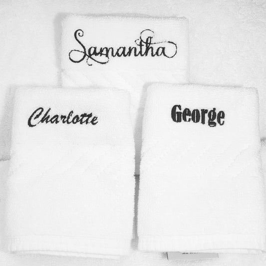 White face towels with embroidered names 'Samantha', 'Charlotte', and 'George' on a white background