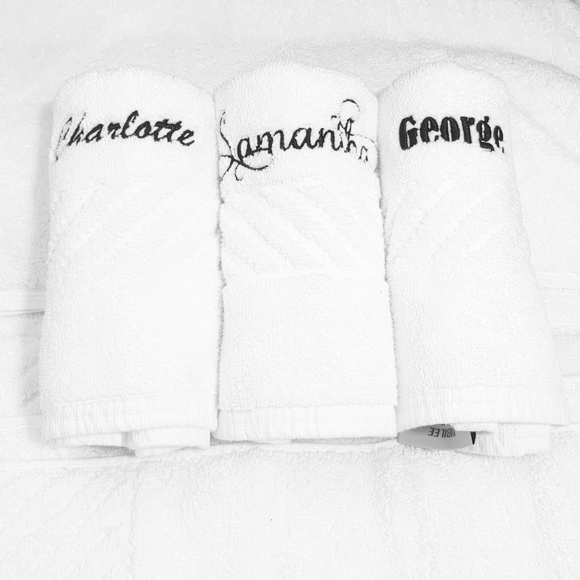 White face cloth with embroidered names on a white background
