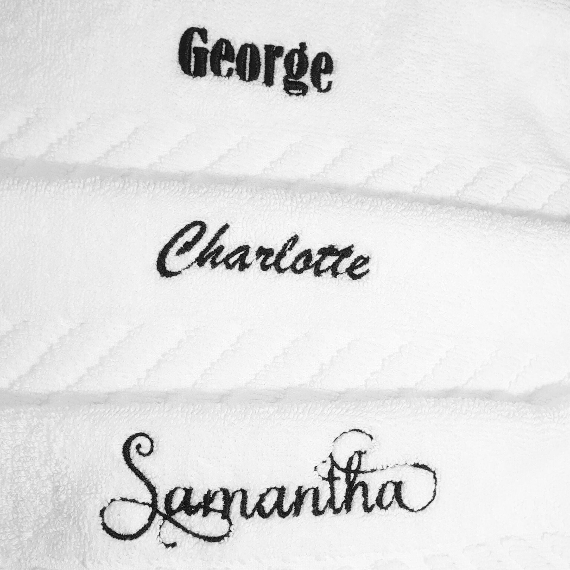 White face towels with embroidered names 'George', 'Charlotte', and 'Samantha' on a white background