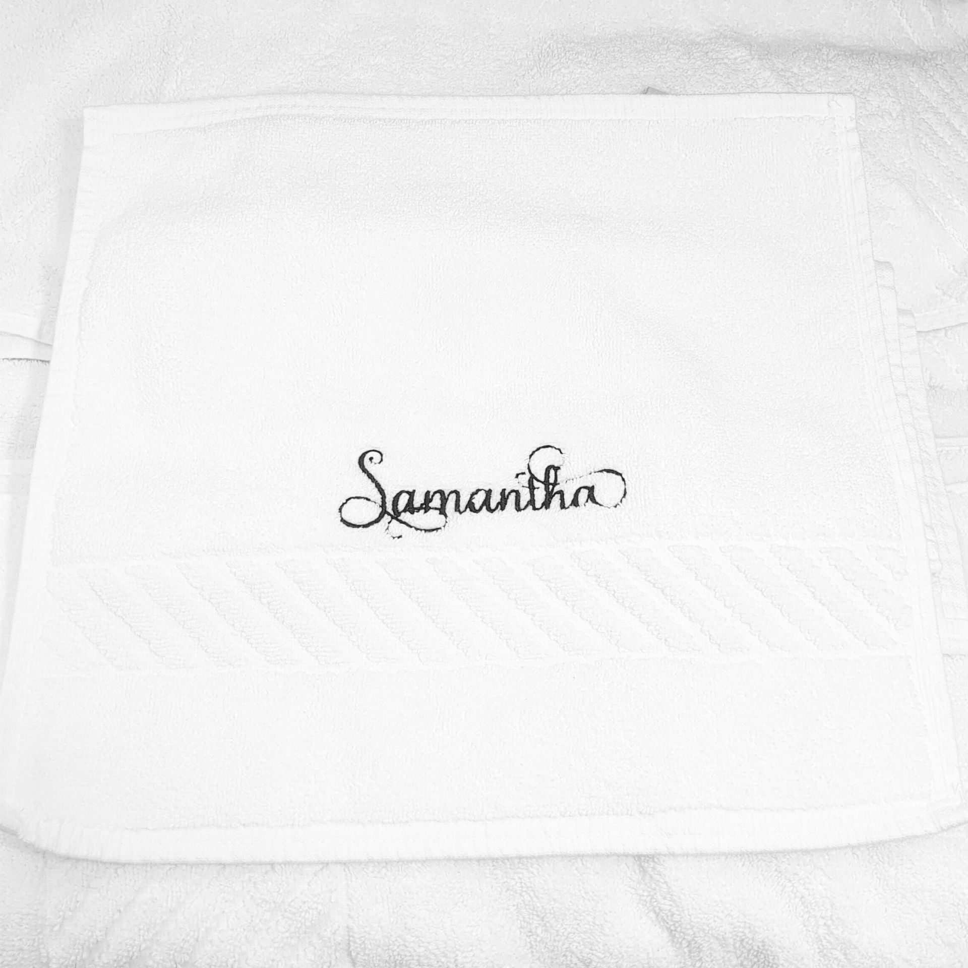 White face towel with 'Samantha' embroidered in black on a white background
