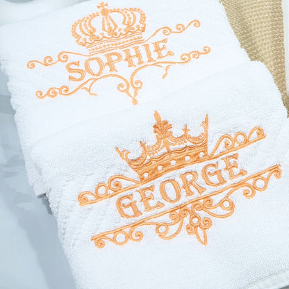 White towel with embroidered names 'Sophie' and 'George' in orange.