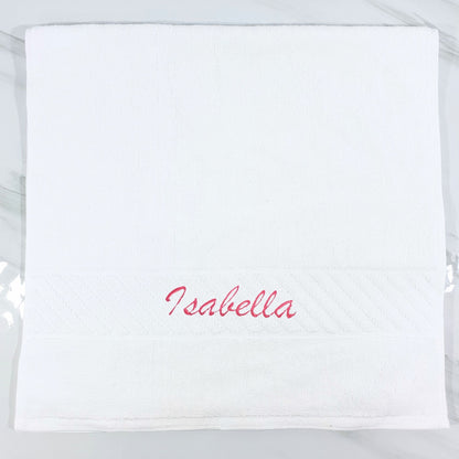 White hand towel with 'Isabella' embroidered in red on a white background